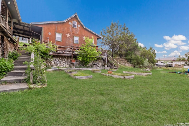 view of yard with stairway and a vegetable garden