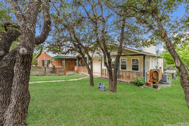 view of front of property with a chimney, central AC, covered porch, and a front yard