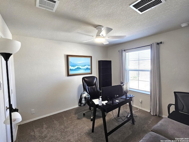 office space with a ceiling fan, visible vents, and dark colored carpet