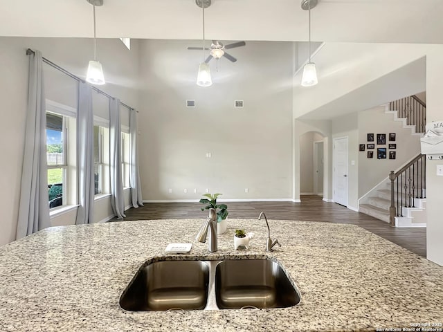 104 Talavera, Boerne, TX 78006 - kitchen featuring a sink, arched walkways, wood finished floors, a towering ceiling, and a ceiling fan