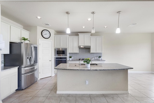 104 Talavera, Boerne, TX 78006 - kitchen featuring stainless steel appliances, tasteful backsplash, light tile patterned flooring, white cabinetry, and recessed lighting
