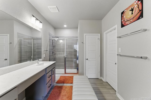 full bathroom featuring visible vents, recessed lighting, vanity, and a shower stall