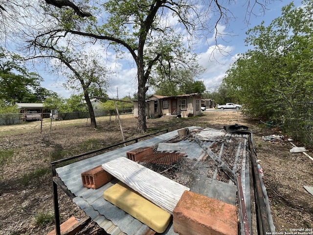 view of yard with fence and an outdoor structure