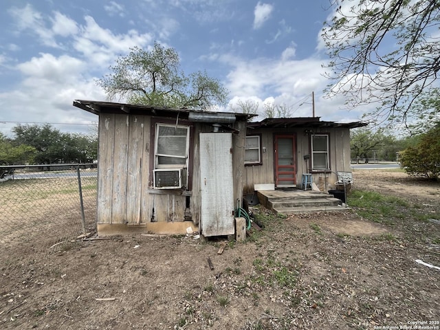 view of outbuilding featuring fence and cooling unit