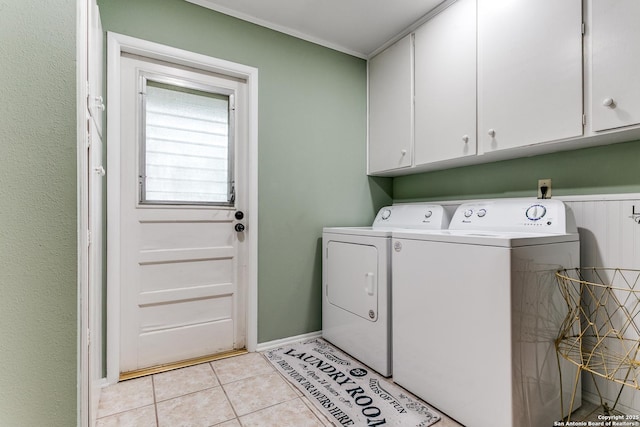 laundry area with baseboards, cabinet space, independent washer and dryer, and light tile patterned floors