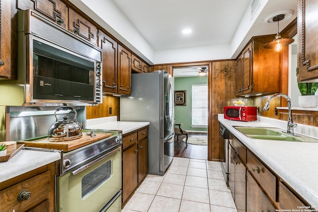 kitchen featuring a sink, appliances with stainless steel finishes, and light countertops
