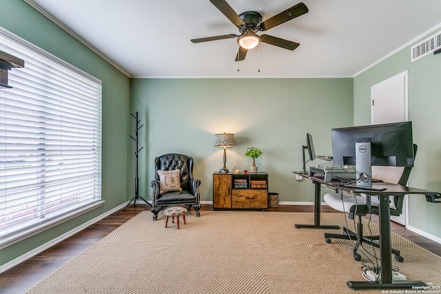office area with crown molding, baseboards, ceiling fan, and visible vents