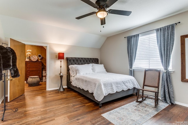 bedroom with baseboards, a ceiling fan, vaulted ceiling, and wood finished floors