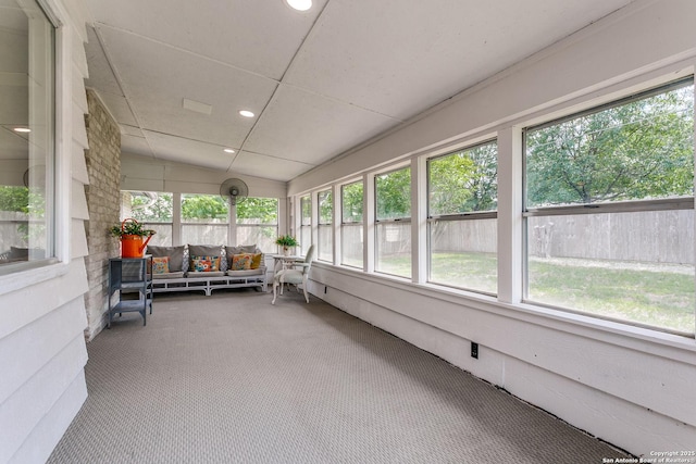 sunroom / solarium featuring an outdoor living space and a wealth of natural light
