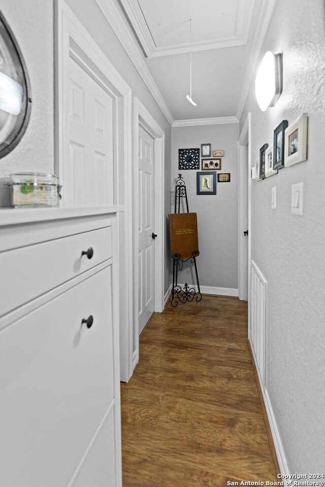 6377 County Road 659, Brazoria, TX 77422 - hall with ornamental molding, a textured wall, wood finished floors, baseboards, and attic access