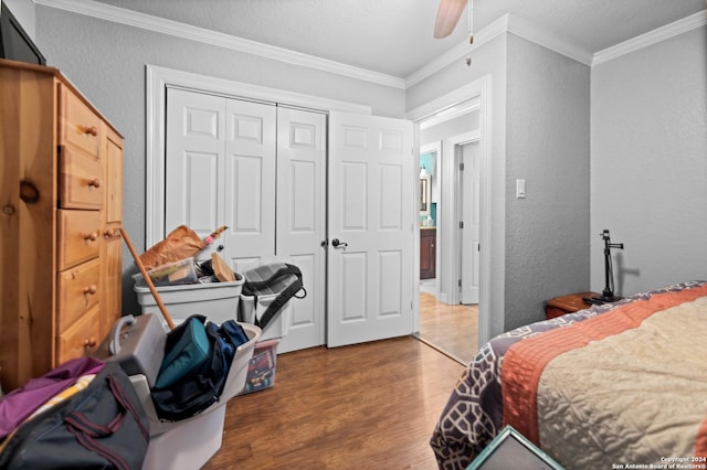 6377 County Road 659, Brazoria, TX 77422 - bedroom with a closet, ornamental molding, a textured wall, and wood finished floors