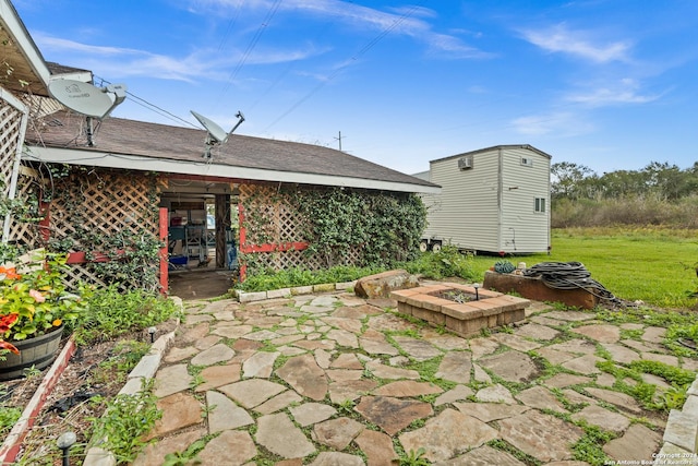 6377 County Road 659, Brazoria, TX 77422 - view of patio featuring an outdoor structure, a shed, and an outdoor fire pit