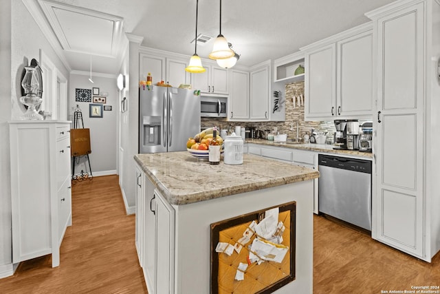 6377 County Road 659, Brazoria, TX 77422 - kitchen with decorative backsplash, open shelves, stainless steel appliances, and white cabinetry