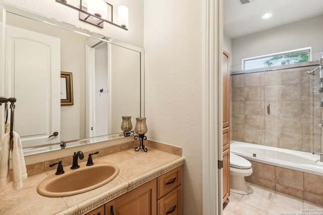 bathroom with tiled shower / bath combo, toilet, tile patterned floors, and vanity
