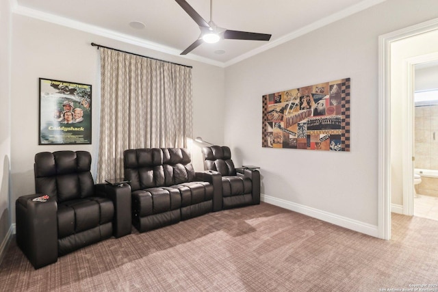 carpeted cinema room with baseboards, ceiling fan, and ornamental molding