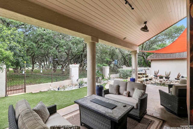 view of patio with an outdoor living space and a fenced backyard