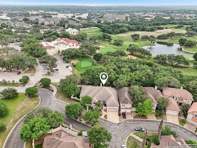 birds eye view of property with a water view, view of golf course, and a residential view
