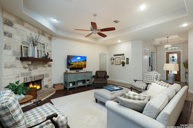 213 Heavens Way, San Antonio, TX 78260 - living area with dark wood-style flooring, visible vents, arched walkways, baseboards, and a tray ceiling