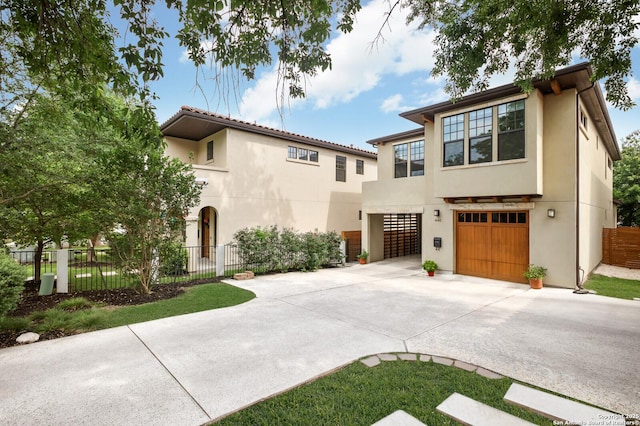 440 E Olmos, San Antonio, TX 78212 - view of front of house featuring driveway, stucco siding, an attached garage, and fence