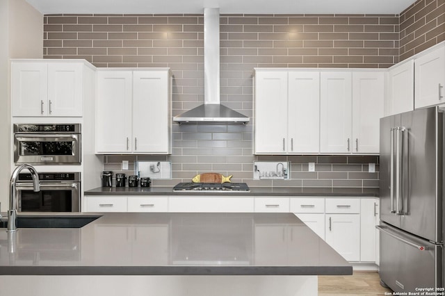 440 E Olmos, San Antonio, TX 78212 - kitchen with appliances with stainless steel finishes, dark countertops, white cabinets, and wall chimney exhaust hood