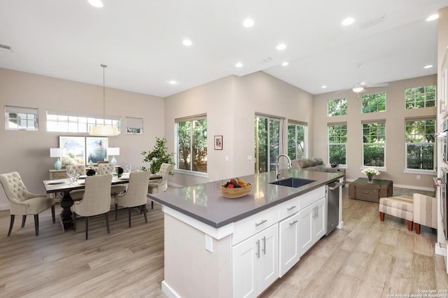 440 E Olmos, San Antonio, TX 78212 - kitchen featuring a sink, open floor plan, ceiling fan, light wood-style floors, and dark countertops