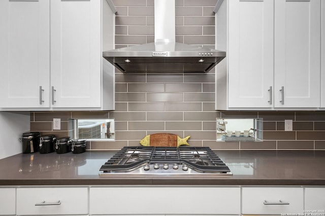 440 E Olmos, San Antonio, TX 78212 - kitchen featuring wall chimney exhaust hood, stainless steel gas cooktop, white cabinets, and tasteful backsplash