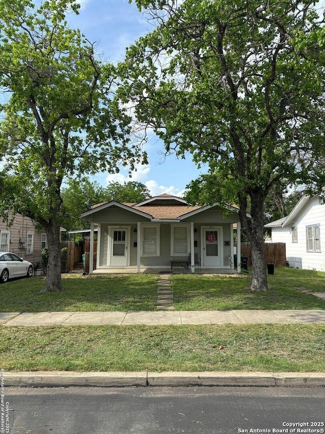 bungalow-style home featuring fence and a front yard