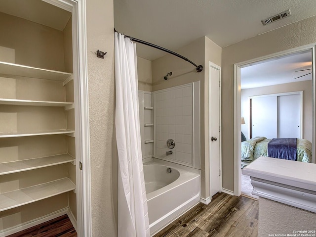 ensuite bathroom with shower / bath combo with shower curtain, baseboards, wood finished floors, ensuite bathroom, and visible vents