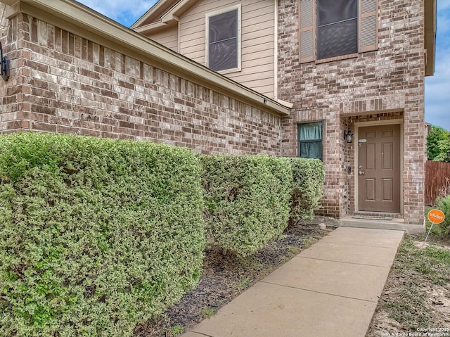 property entrance featuring brick siding
