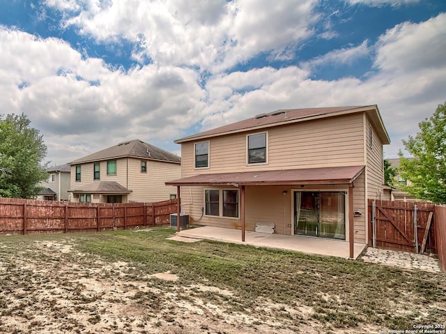 back of property featuring a fenced backyard, a yard, cooling unit, and a patio area