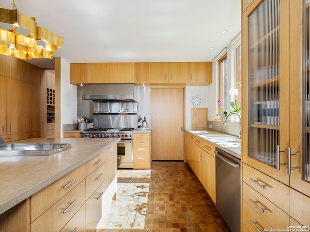kitchen featuring range hood, a sink, light countertops, light brown cabinets, and stainless steel appliances