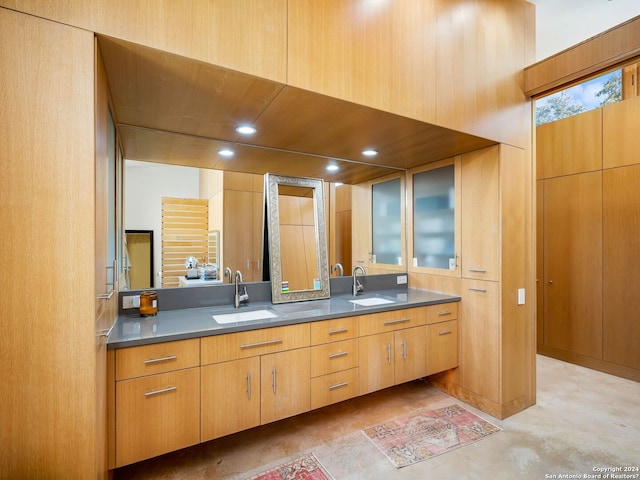 full bathroom with double vanity and a sink
