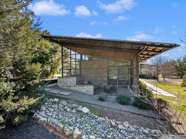 view of patio featuring a sunroom