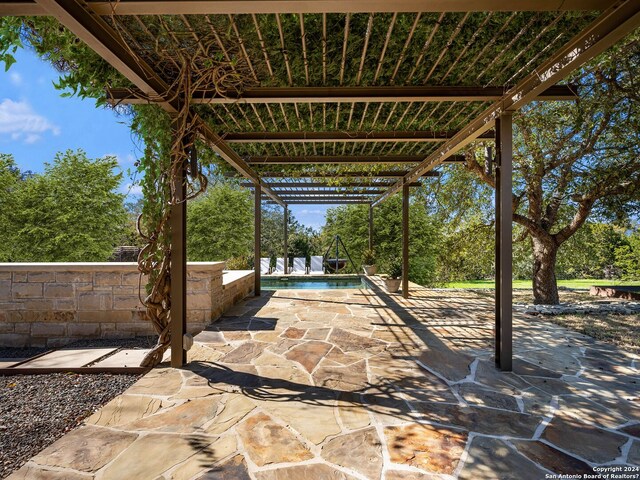 view of patio with an outdoor pool and a pergola