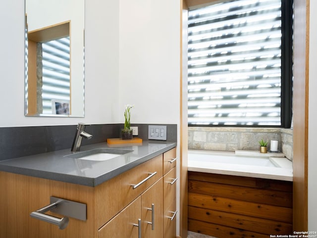 bathroom with plenty of natural light and vanity