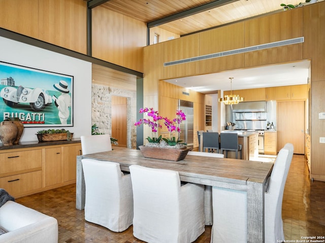 dining area featuring a high ceiling and a chandelier