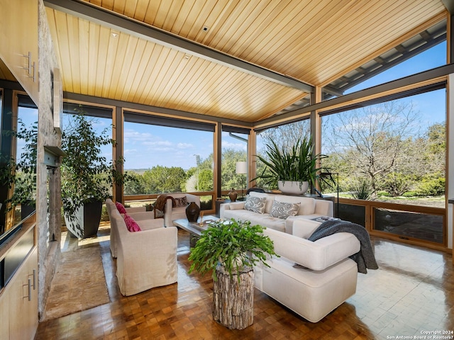sunroom / solarium with vaulted ceiling, expansive windows, and an outdoor hangout area