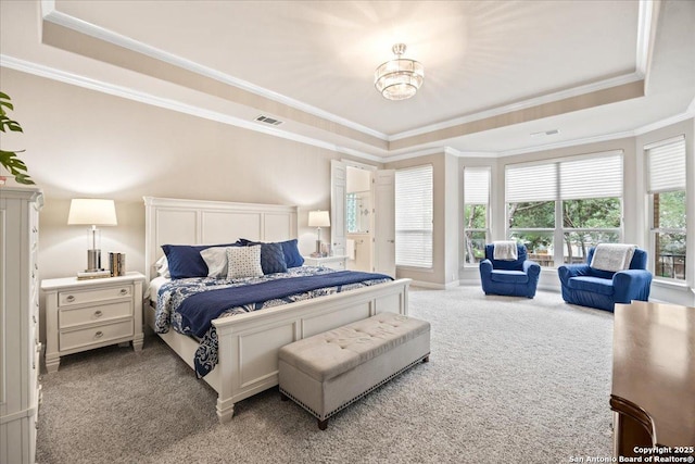bedroom featuring carpet floors, crown molding, visible vents, and a raised ceiling