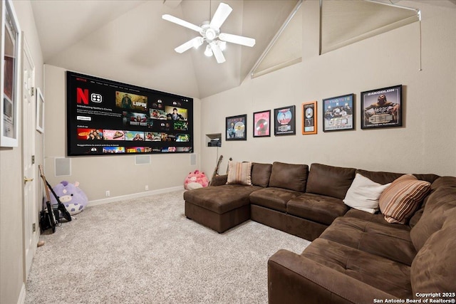 carpeted cinema room featuring a ceiling fan, high vaulted ceiling, and baseboards