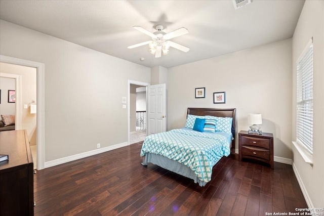 bedroom featuring baseboards, multiple windows, wood finished floors, and visible vents