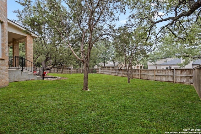 view of yard with a fenced backyard