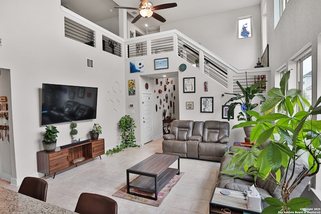 5707 Pin Pt, San Antonio, TX 78266 - living area featuring ceiling fan, a high ceiling, baseboards, light tile patterned floors, and visible vents