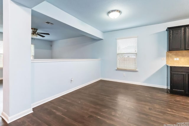 407 Wind Gust, New Braunfels, TX 78130 - unfurnished dining area with a ceiling fan, dark wood finished floors, and baseboards