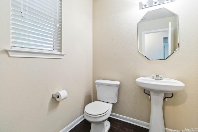 407 Wind Gust, New Braunfels, TX 78130 - half bathroom featuring toilet, a sink, and wood finished floors