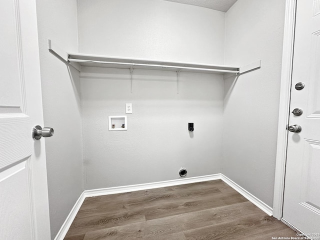 clothes washing area featuring hookup for an electric dryer, laundry area, wood finished floors, baseboards, and hookup for a washing machine