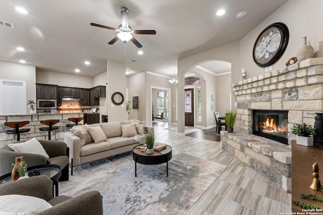 living area featuring recessed lighting, arched walkways, and ceiling fan