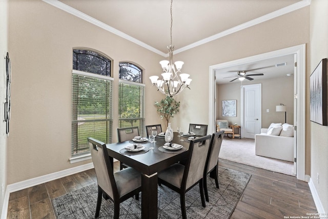 dining area featuring crown molding, a notable chandelier, dark wood finished floors, baseboards, and visible vents