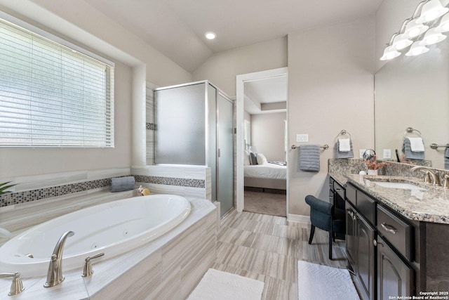 bathroom featuring ensuite bath, a shower stall, a jetted tub, and vanity