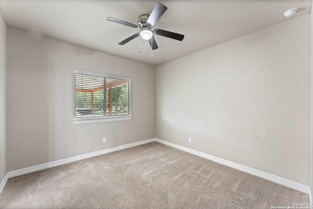 unfurnished room featuring carpet flooring, a ceiling fan, and baseboards