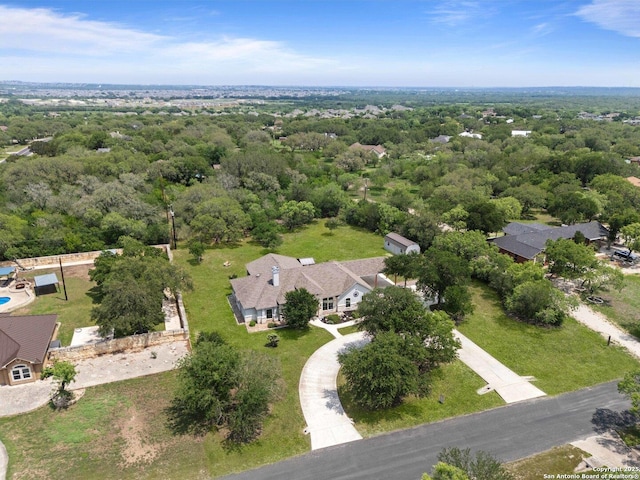 birds eye view of property with a forest view